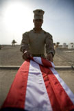 Soldier Folds Flag